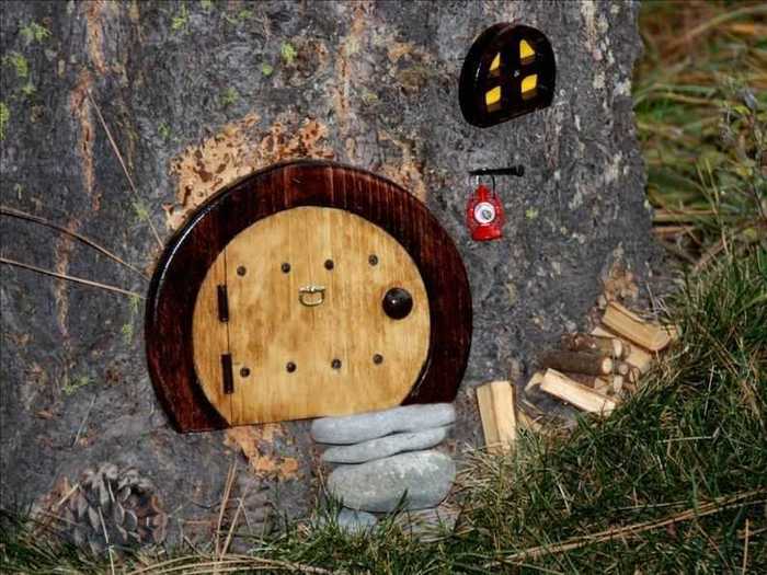 A tiny elf door is built into the tree.