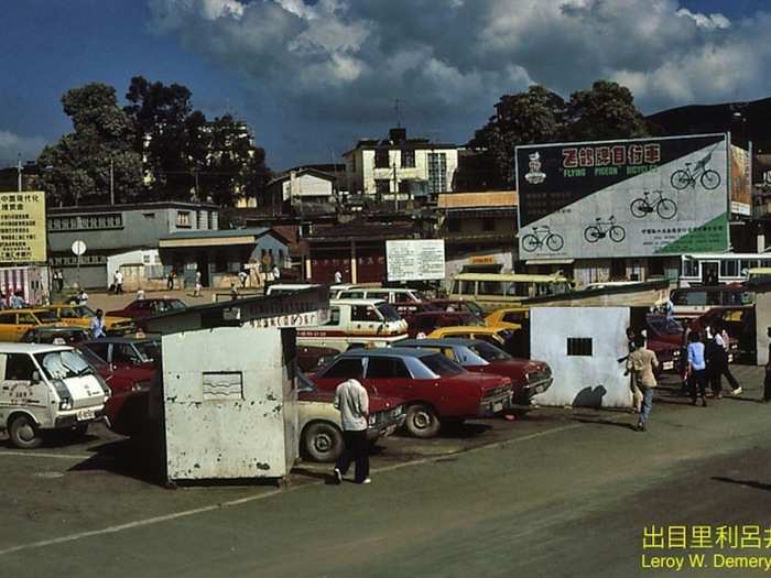 I am no automobile expert but some of the vehicles in this photograph have a distinctly American look.