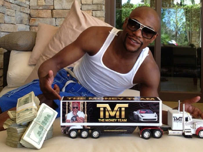 9. His "The Money Team" Hess truck next to stacks of cash.