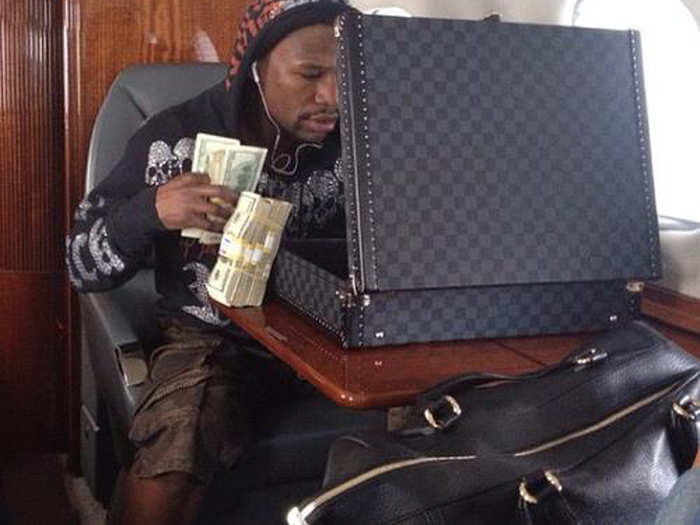 15. On his private jet with a briefcase full of money.