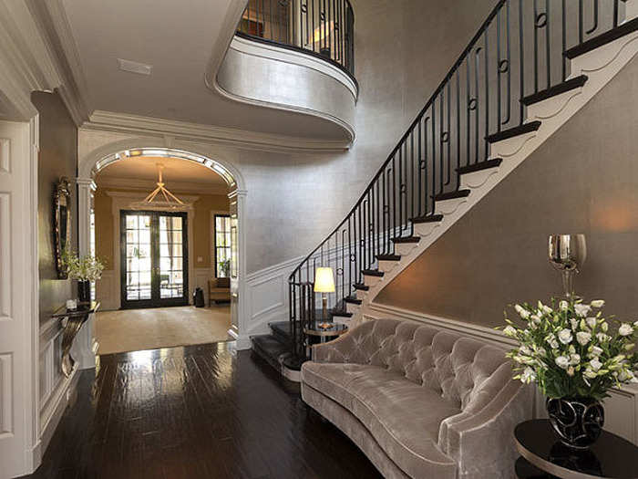 The entryway is two stories and includes a dramatic curved stairway.