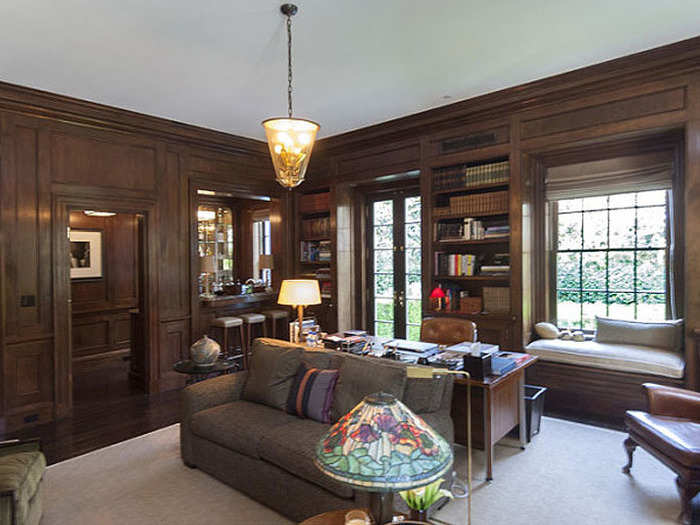 The wood paneled den is perfect for cozying up with a good book and a glass of Scotch.