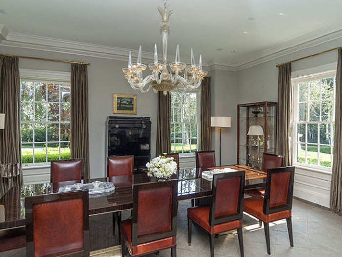 The dining room can easily fit a party of 10, and has an elegant chandelier dangling from the ceiling.