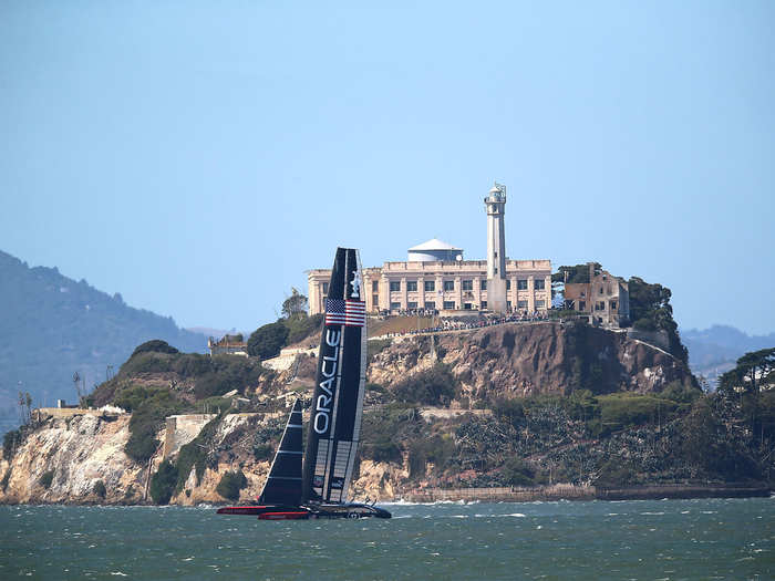 The teams sail past Alcatraz Island during Race 18.