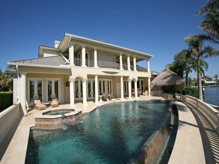 Infinity-edge pool complemented by a balcony and Tiki hut