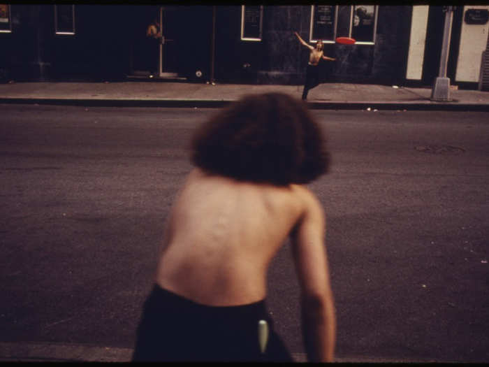 Playing Frisbee in the street.