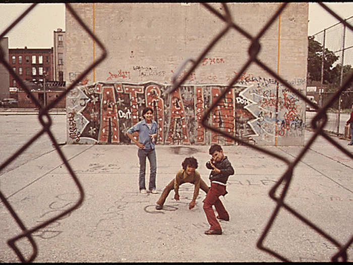 Three boys and " A Train" graffiti in Brooklyn