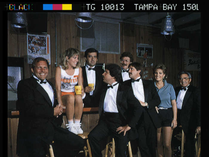 Here are the founders of Hooters dressed up alongside waitresses.