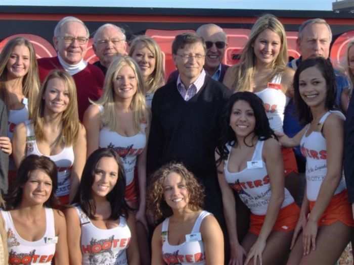 Bill Gates and Warren Buffett pose with Hooters girls.