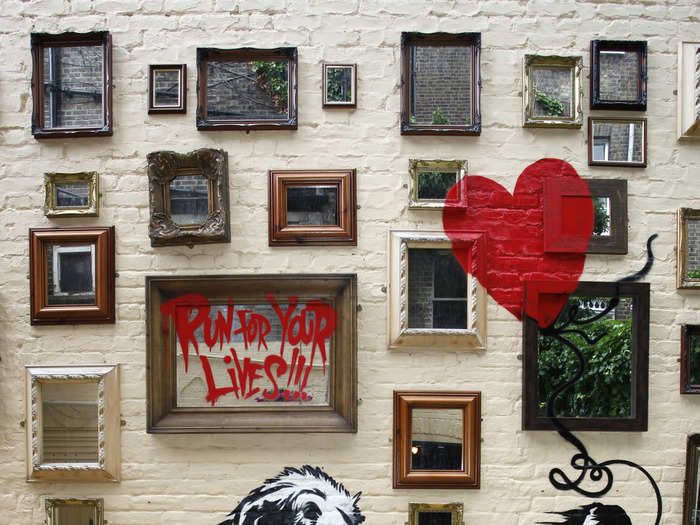 Banksy was caught on tape while painting this mural at a London pub. It features his signature red balloon.