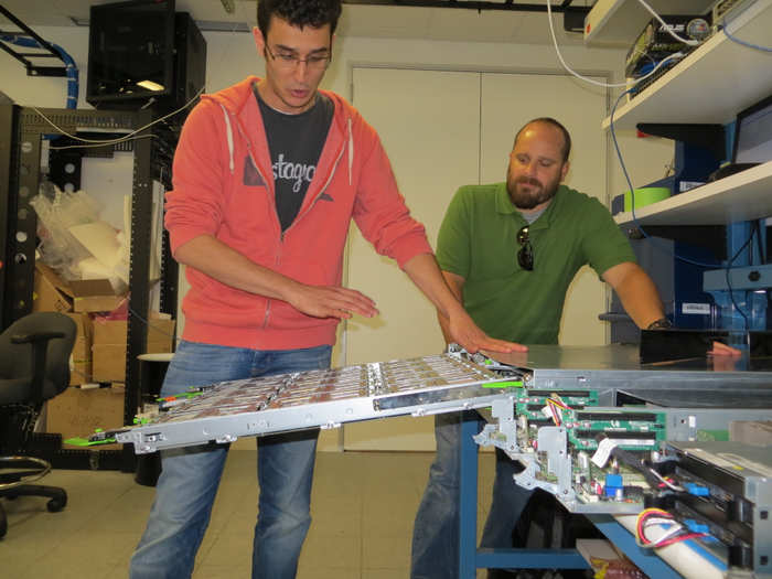 Tal and Michael Kirkland, engineering PR, show off how the Knox box tilts. Dozens of drives are stacked in that box spinning like tiny record players. Facebook invented a way to move and tilt them without breaking them.