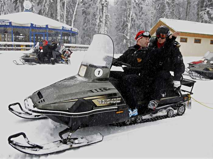 Here, Putin and Russian Prime Minister Dmitry Medvedev ride a snowmobile at an Olympic alpine ski park. The pair will later hit the slopes.