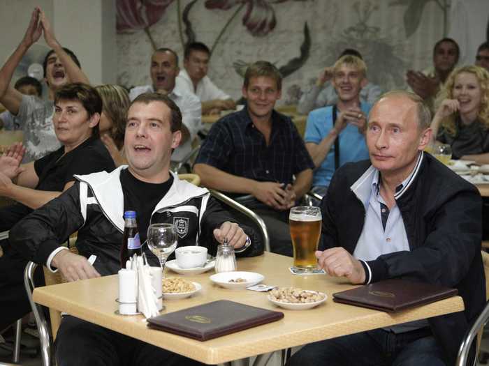 And in this shot, Putin kicks back and relaxes with loyal second in command Dmitry Medvedev as they watch a soccer match.
