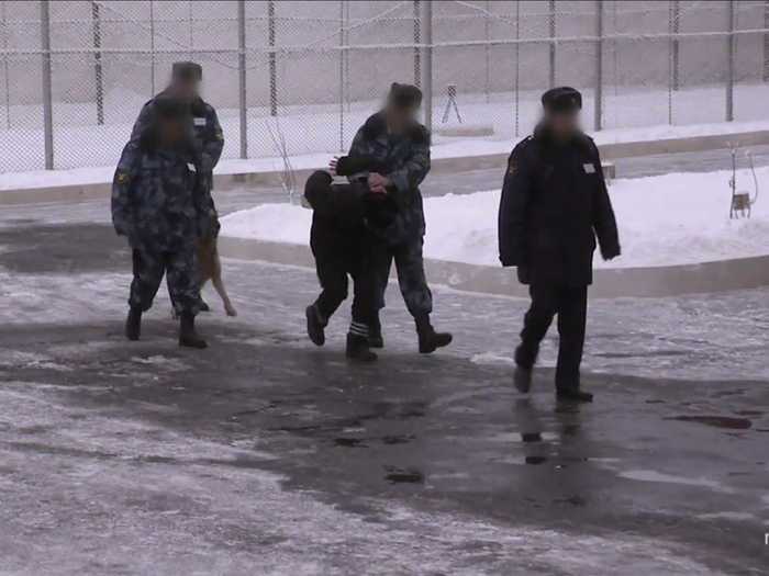 Inmates are blindfolded when they walk outside.