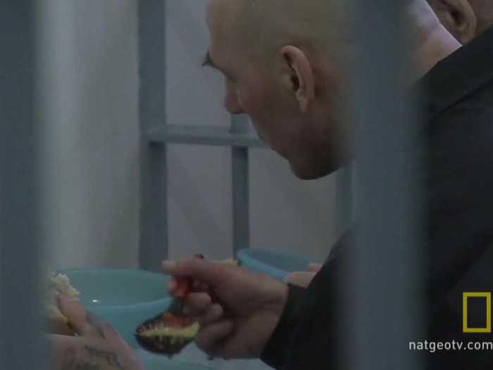 Prisoners eat their meals in their cells.