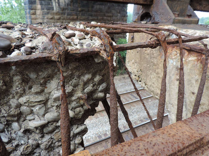 Hartle says you can see "local failures of the reinforced concrete safety curb/walkway atop a retaining wall."