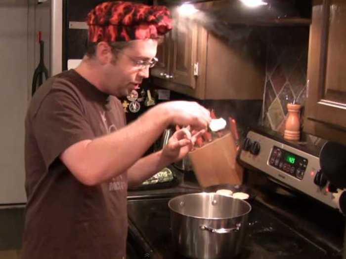 At the four minute mark, lift the poached egg out of the water with your slotted spoon.