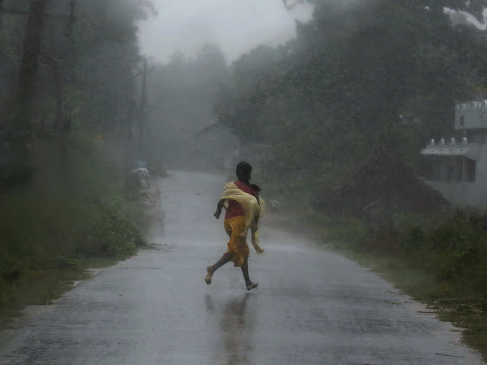 A girl runs for shelter in heavy rain brought by Cyclone Phailin in Ichapuram town in Srikakulam district in the southern Indian state of Andhra Pradesh.