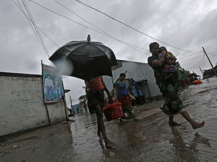 A woman carries her baby as she moves to a safer place with others at the village Donkuru.