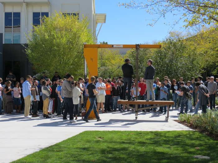 On this day, Facebook was launching a 24-hour hackathon. Lots of products came from hackathons including Facebook Chat and the new Facebook WiFi launched with Cisco. People gather by the yellow crane ...