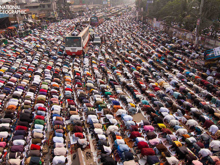 People praying in the streets at Ijtema, the second largest Muslim gathering in the world. The gathering is so huge that the praying spilled out from the field into the road.