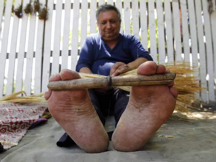 This man is handmaking a broom which he will sell at a market for 1.7 Euros. Gypsies tend to work jobs that they can perform independently.