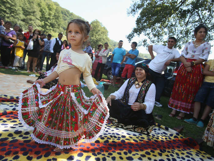 At an annual gathering for the Kalderdash clan, three-year-old Maria shows off her belly-dancing skills. The Kalderash were once coppersmiths but now deal scrap metal.