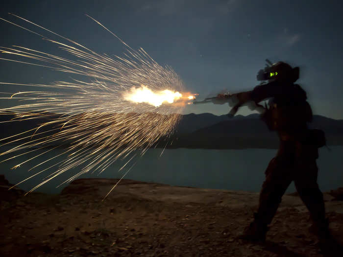 A Marine Special Operations Team member fires an AK-47 during night fire sustainment training in Helmand province, Afghanistan.