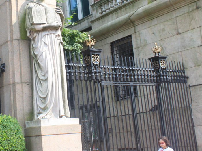 The gate is flanked by two statues. If you look closely at the woman on the southern end, you can see her book has Latin writing, a reference to the importance of the humanities.