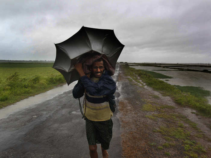 An Indian villager braves strong winds and rain in village Podampeta, in Ganjam district, about 125 miles from the eastern Indian city Bhubaneswar.