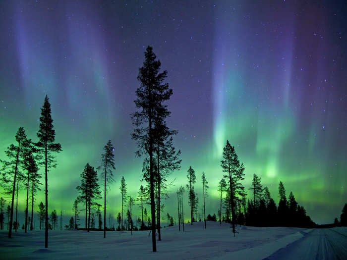 The Aurora borealis photographed in the early morning hours in the Arctic Circle. Also known as the northern lights, the spectacular light show is created when fast-moving charged particles from the sun hit the Earth