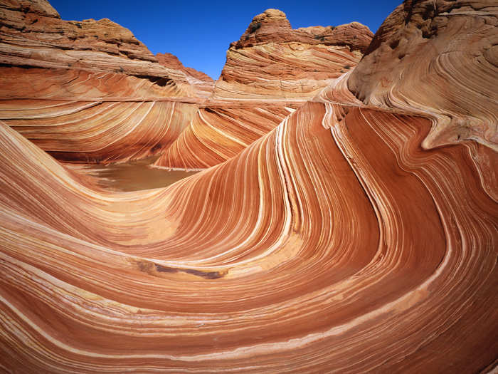 "The Wave" is a sandstone formation located near the Arizona-Utah border. The lines are formed by erosion — different layers of rock erode away at different rates.