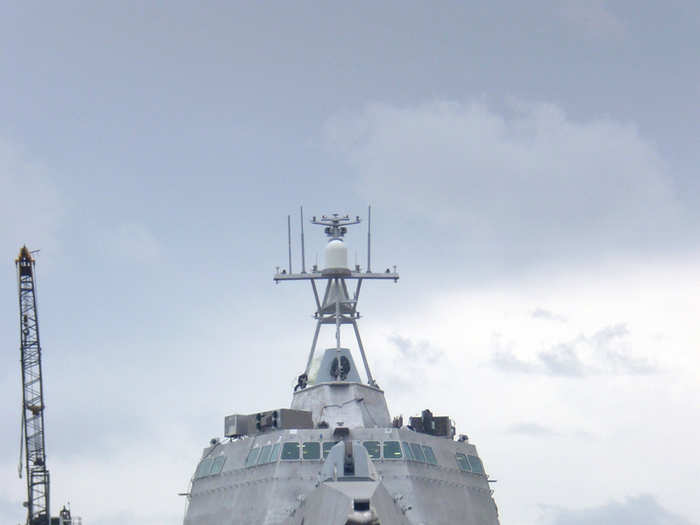 A Rolling Airframe Missile launcher is mounted above the hangar for short-range defense against aircraft and cruise missiles, and .50-caliber gun mounts are provided topside