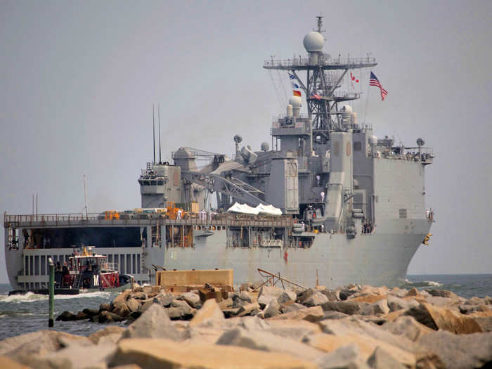 The tugs pull back and the LCAC mothership heads off into the distance under power.