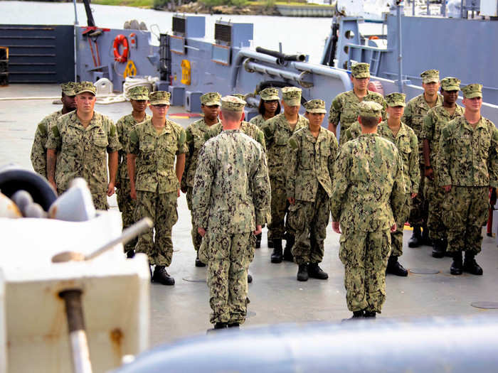 The mixed-gender crew are usually made up of about a dozen members. Here they report to the vessel for morning formation for a day of upkeep and training.