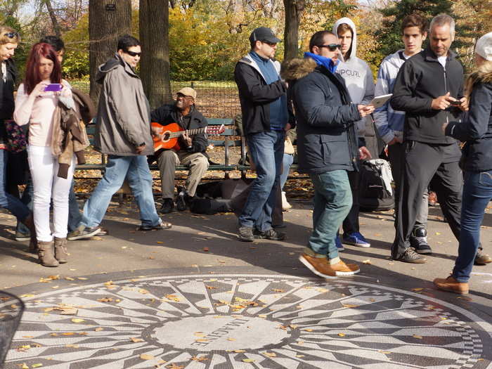 Strawberry Fields on the west side is a cool living memorial to John Lennon. Here, a man sings "I Saw Her Standing There."