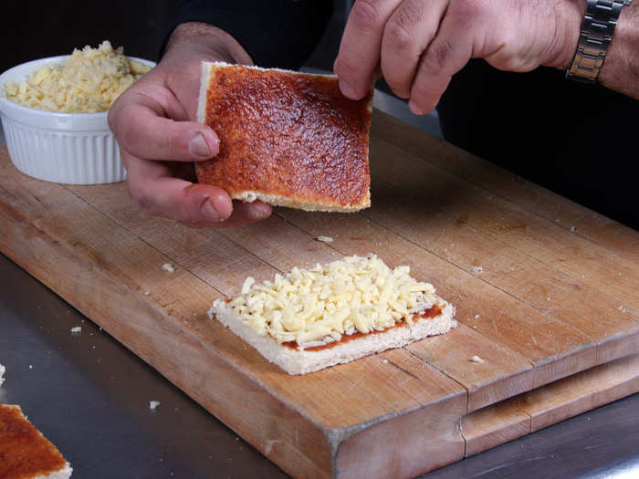 Step 3: Top one slice of bread with shredded aged cheddar and place the other slice, apple butter side down, on top.