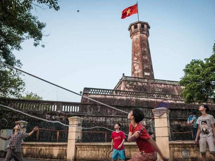 "In Lenin Park, set against the backdrop of the Hanoi Flag Tower which forms part of the Hanoi Citadel, Vietnamese children sparring in a game of badminton." — Justin Tiew