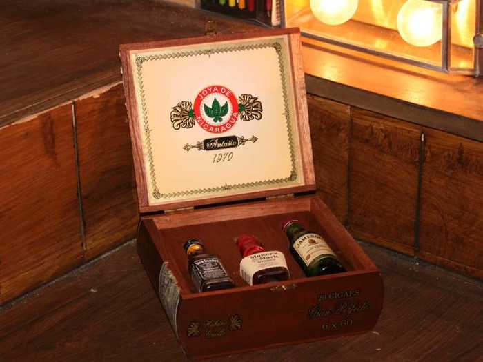 Vintage cigar box with hidden bottles of whiskey