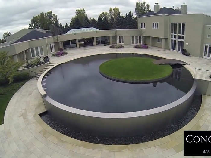 An infinity pool with a grass island in the middle.