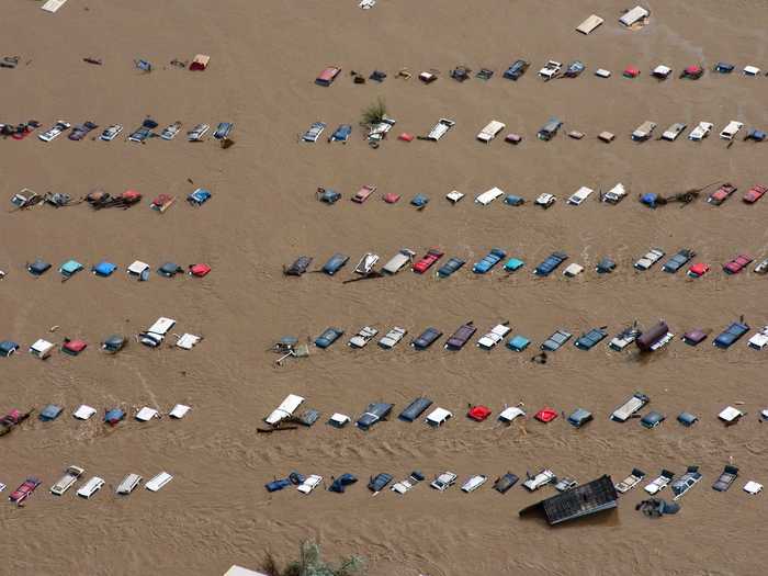 A field of parked cars and trucks sits partially submerged near Greeley, Colo., in September after floods destroyed an area the size of Connecticut.