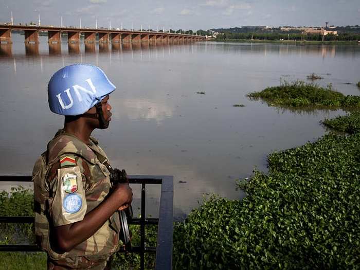 A MINUSMA peacekeeper patrols the grounds of the El Farouk Hotel in Bamako, during a meeting between the Malian government and Tuareg separatist rebels.