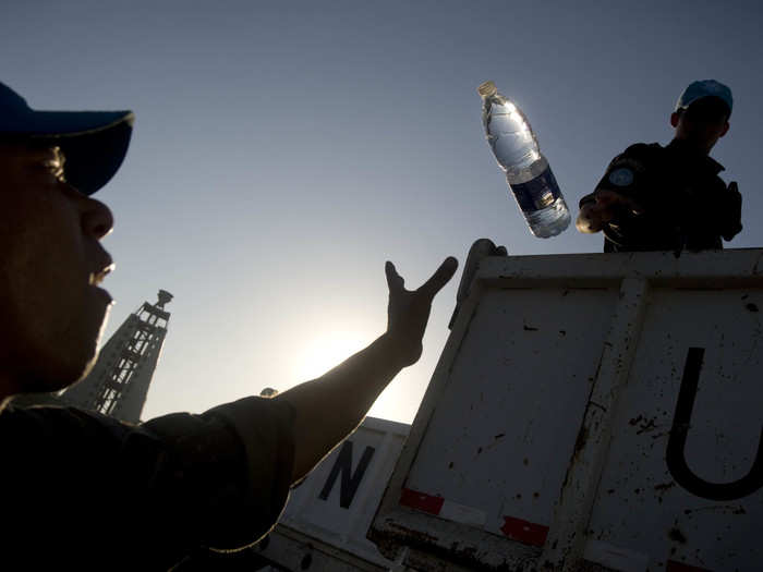 Brazilian UN peacekeepers distribute food and water in downtown Port-au-Prince in the weeks after the devastating earthquake hit the capital.