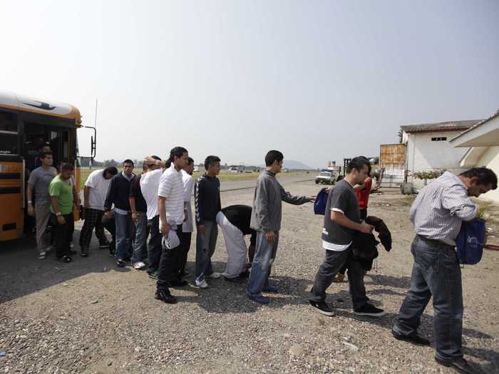 To escape the poor living conditions and violence, many Hondurans flee the country, but the U.S. does its best to send them back. Here, deportees walk toward an immigration office after arriving in San Pedro Sula on a flight from the U.S. In 2012, the U.S. deported more than 32,240 Hondurans by air.