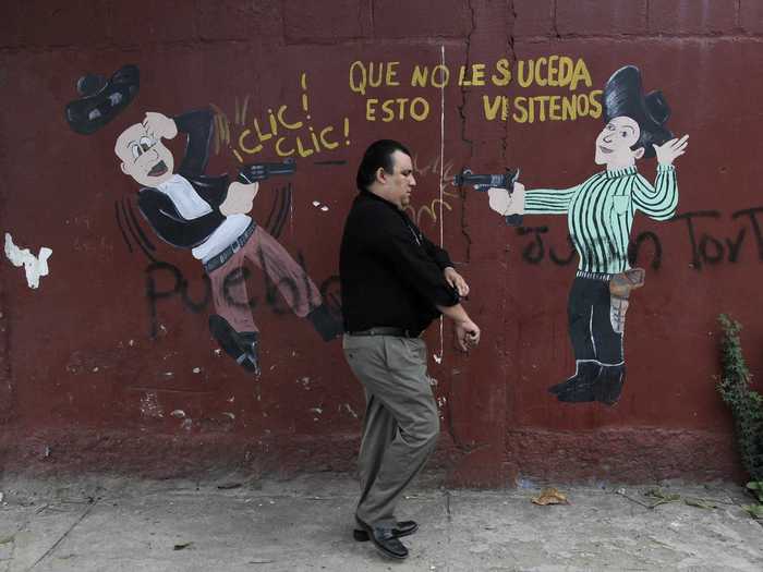 But many worried about increased violence during the election. Journalists in Honduras and even the candidates received death threats. The graffiti below reads, "This may not happen to you, visit us."