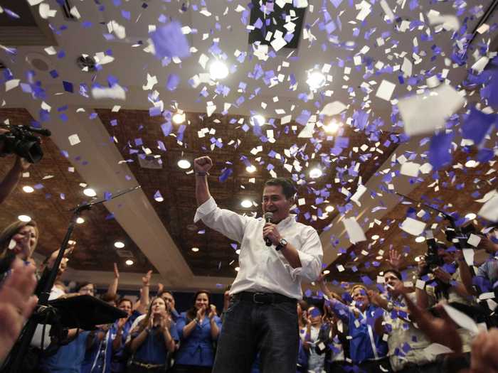 In the end, both candidates — Xiomara Castro, the wife of ousted former President Zelaya, and National Party candidate Juan Hernandez — claimed victory. The electoral authority, however, said a partial tally of votes gave Hernandez nearly 35 percent support and Castro just over 28 percent. Below, Hernandez celebrates his victory.