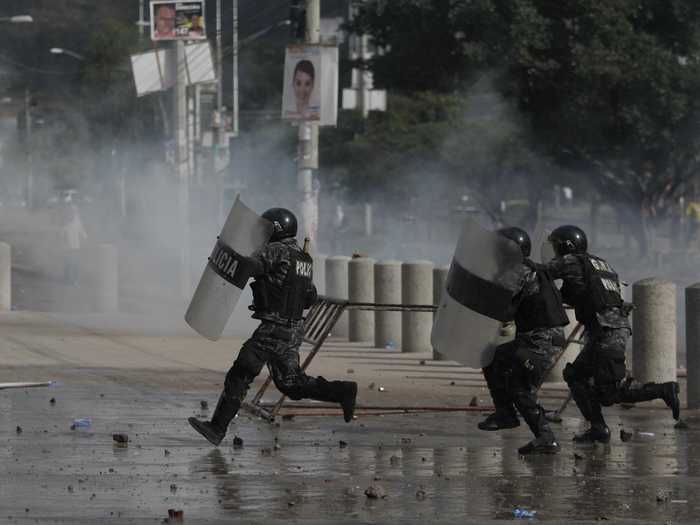 Riots broke out across Honduras because Castro, the losing candidate, denounced the election as a fraud and refused to accept the results. Below, police charge toward student protestors in Tegucigalpa.