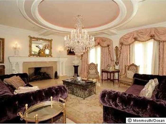 Purple velvet couches provide a jarring pop of color in this sitting room.