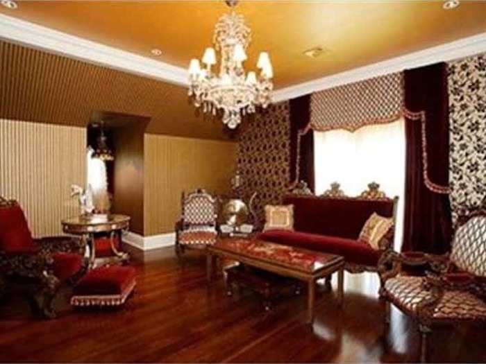 Another sitting area has velvet drapes and upholstered chairs fit for royalty.