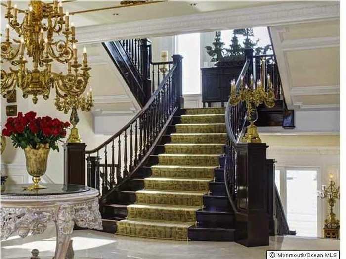 A grand staircase leads to the upper floor.